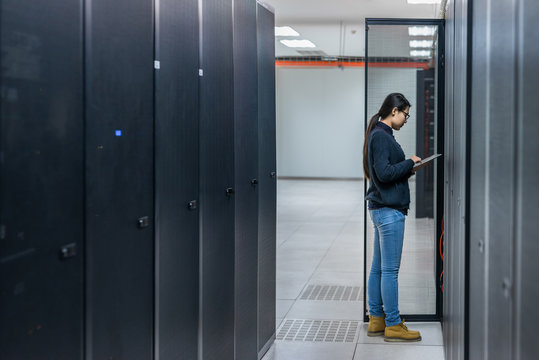 Female technician working in data center