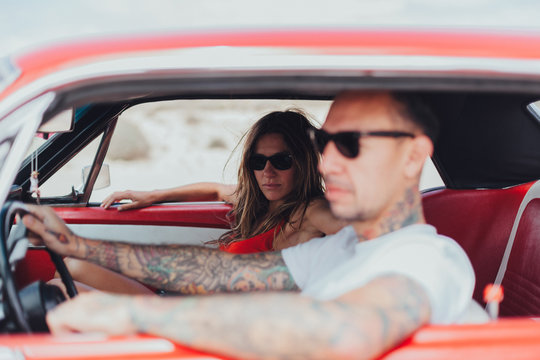 Couple Traveling with an American Vintage Car