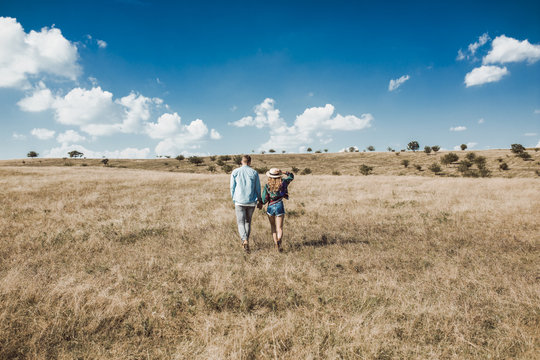 Couple Walking in A Field