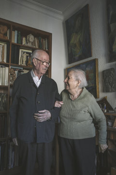 Portrait of old couple standing on artistic studio in home 