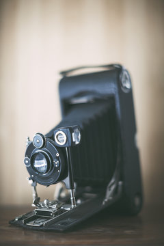 Antique film camera on wooden table