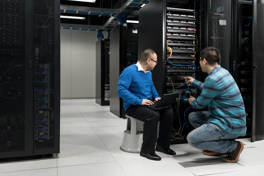 Engineers working on server in data center