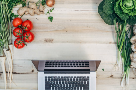 Table with vegetables and computer