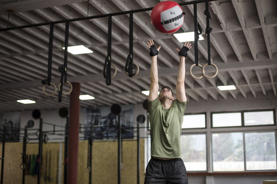 Man Doing Exercise with Medicine Ball