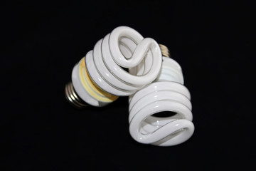 Closeup of two fluorescent light bulbs isolated on a black background