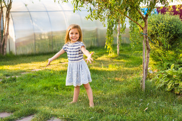 happy child girl playing in summer in nature