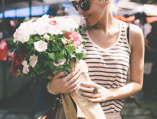 Smiling Woman Smelling Flowers