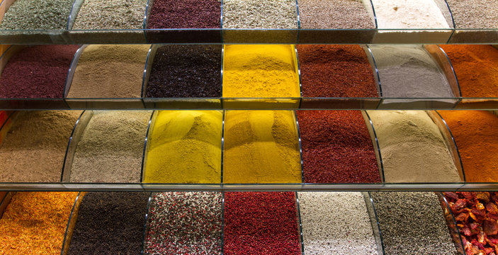 Multicolored spices, teas and nuts on the counter in the market