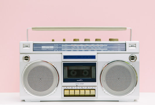 Retro ghetto blaster tape deck over pastel pink background