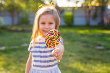 cute cauasian baby girl and big lollipop