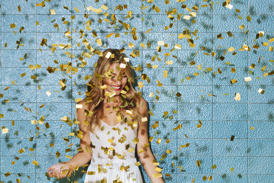 Portrait of Woman Covered With Golden Shining Confetti