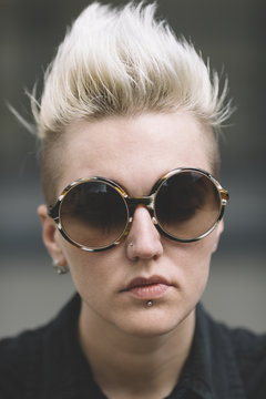 blond butch with mohawk and round sunglasses 