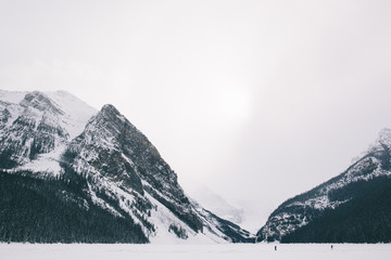 Exploring a frozen lake with large mountains in the background