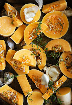 Butternut squash,smoked garlic and thyme in a roasting tin,ready to be cooked