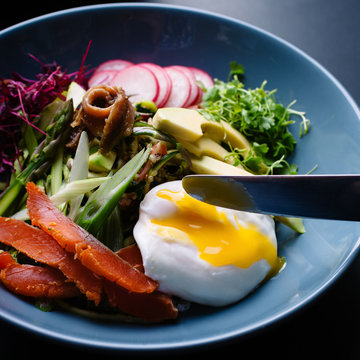 Healthy salad bowls Poached egg with runny yolk