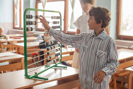 Boy Calculating on an Abacus