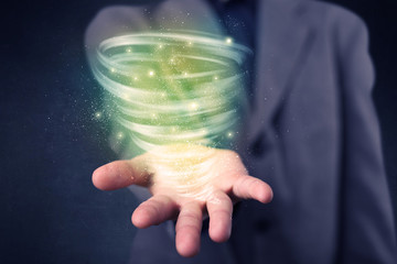Businessman holding green tornado