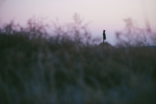 Young chinese woman walking on a grassland
