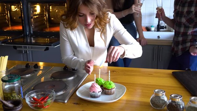 girl light a candle on a cupcake at home