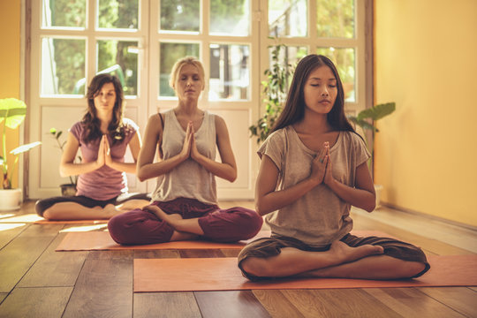 Three women meditating