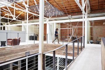 Millennial using ipad at work at high tech office