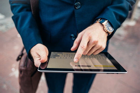 Businessman With a Tablet - Powered by Adobe