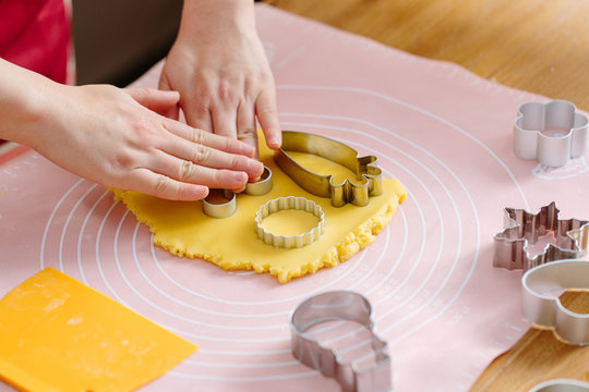  Baker using cookie cutter in dough