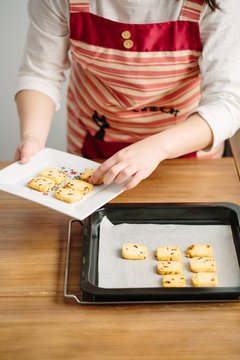 Young Chinese woman baking cookies