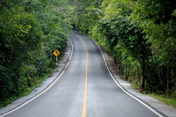 curve concrete road  way to wild