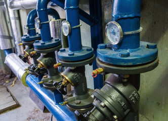 Heat-regulating equipment in the basement of a heated building / Photo taken in Russia. Heating systems for apartment houses and heat meters