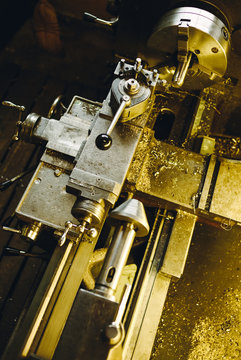 old vintage engine lathe shining in golden colors