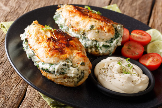 Delicious food: Baked chicken fillet stuffed with cheese and spinach close-up. horizontal