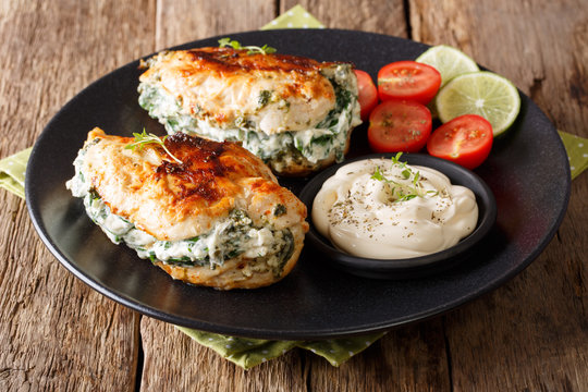 Baked chicken breast stuffed with cheese and spinach, close-up. horizontal
