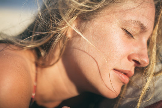 Beauty shot of blonde beach babe soaking in the sun's afternoon rays