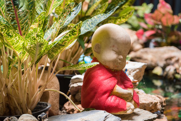Closeup the Beautiful small statue of a novice in Wat Borom Raja Kanjanapisek Wat Leng Nei Yee 2 Temple, People go to temple to pray for good luck and success in life.