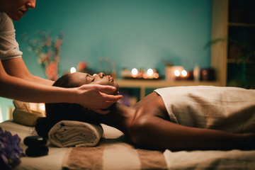Woman receiving a head massage at spa