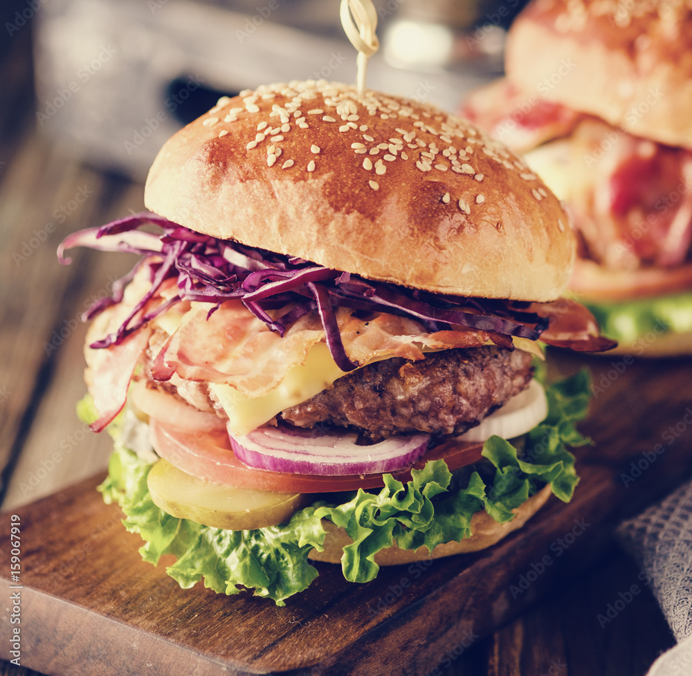 Wall mural delicious homemade hamburger on wooden background.