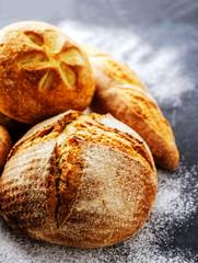 Homemade fresh bread on the dark table