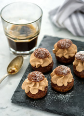 Cake shu on the stone board with coffee