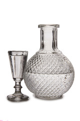 Vodka in a glass and decanter on a white background