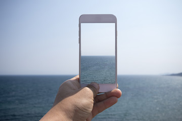 taking a photo of ocean scene with smartphone