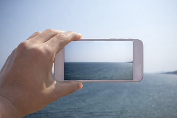 taking a photo of ocean scene with smartphone