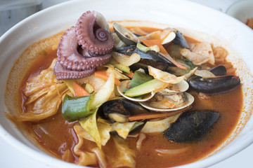 spicy noodle soup with seafood and octopus