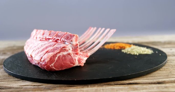 Raw beef ribs and ingredients on wooden board