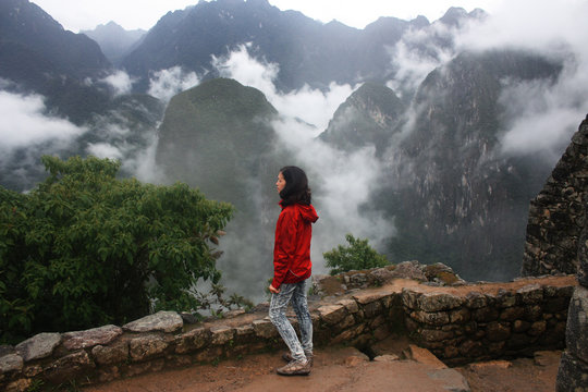 mid age woman looking at mountains machu picchu, Peru
