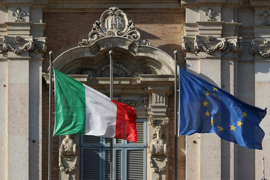 Italian and European Union flags in the wind on the public palace