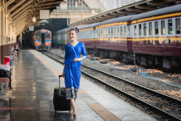 Beautiful Thai girl in Thai costume,Asian woman wearing traditional Thai culture at train station,Bangkok.