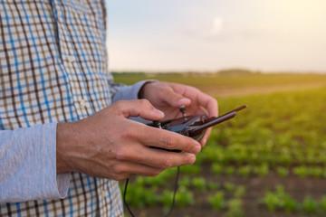 Hands of farmer using drone remote control