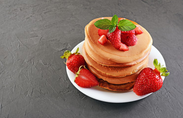 Tasty breakfast. Homemade pancakes with fresh strawberry and mint