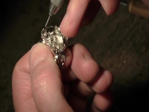 Jeweler is drilling a hole for setting a precious stone.